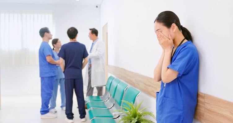 Nurse crying while coworkers talk behind her - Hostile Work Environment